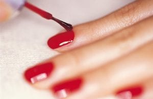 Red nails being painted