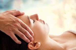 woman getting head massaged at the spa