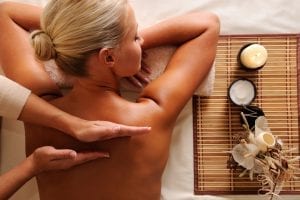 Woman getting recreation massage in spa salon - high angle